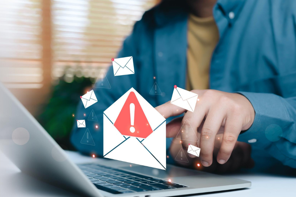 Phishing email warning displayed on laptop screen in office environment