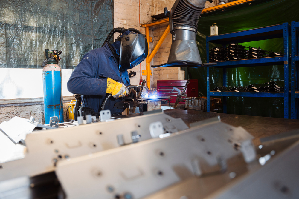 Highly skilled welder working in the fabrication shop at Grenville Engineering