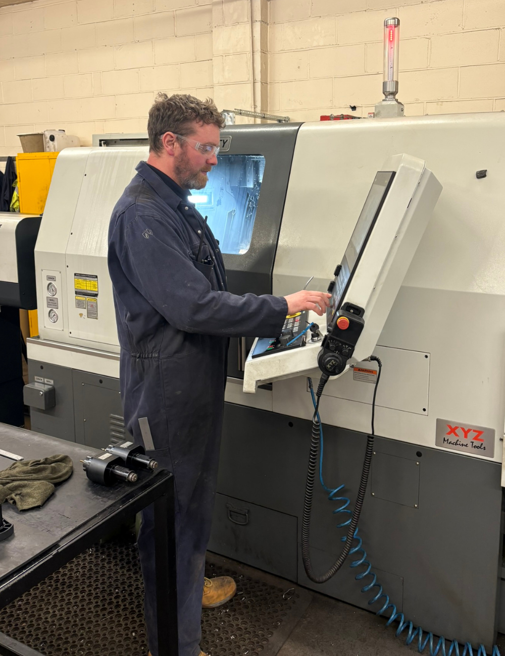 Cell leader operating CNC machining centre at Grenville Engineering