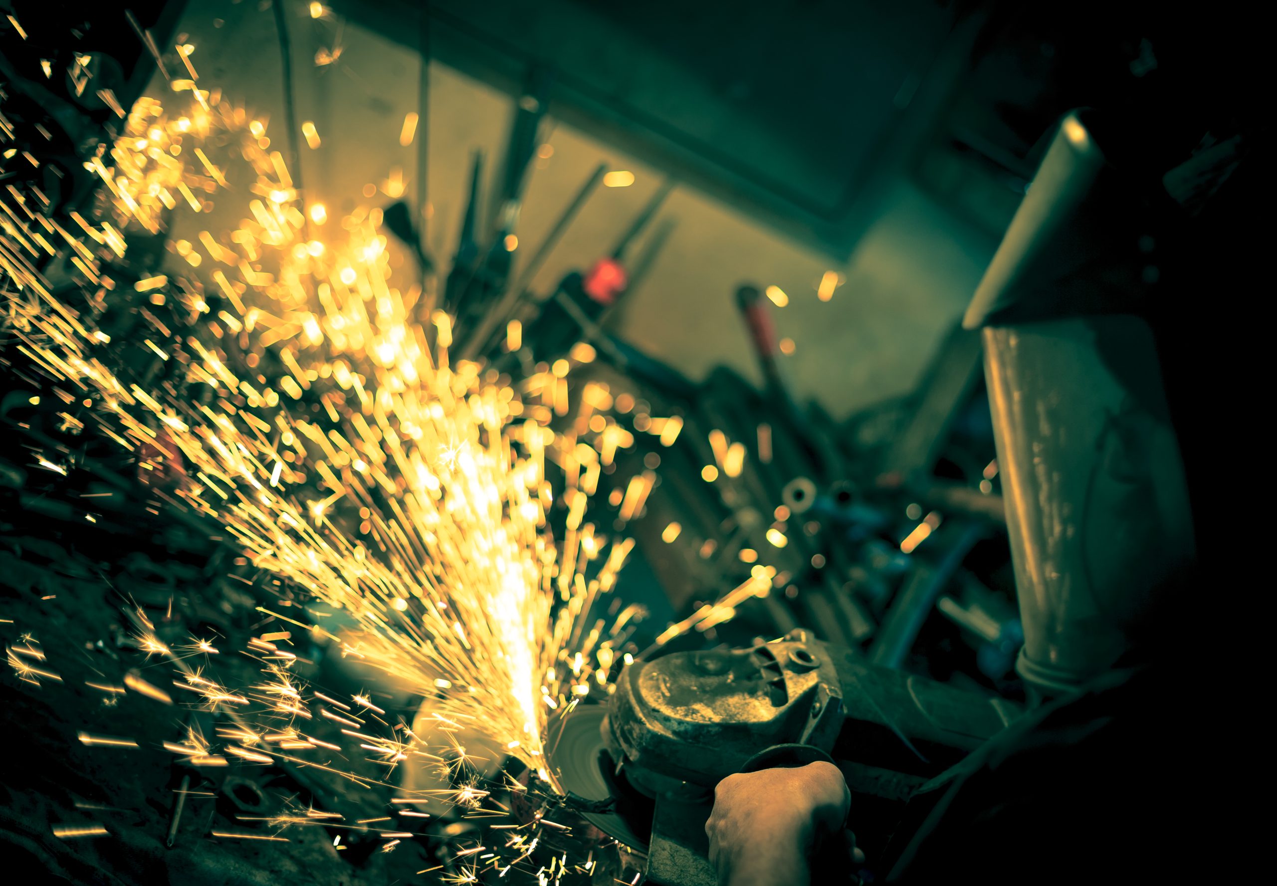 Man is using a grinder on metal<br />
