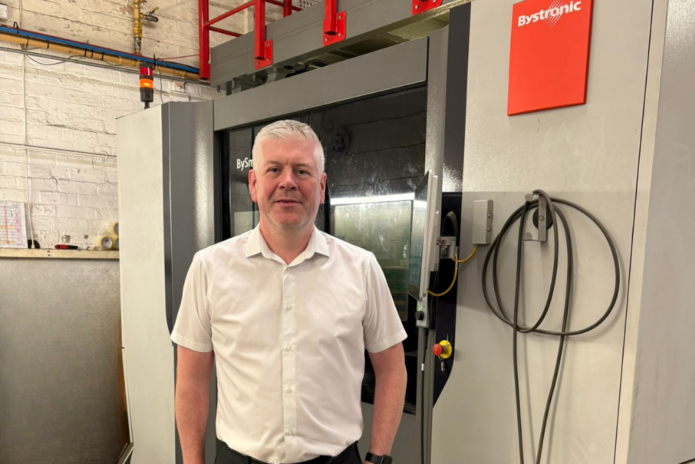 stuart-rawlinson-bystronic-laser-cutting-machine-grenville-engineering Stuart Rawlinson, Sales Director at Grenville Engineering, standing in front of a Bystronic fibre laser cutting machine.