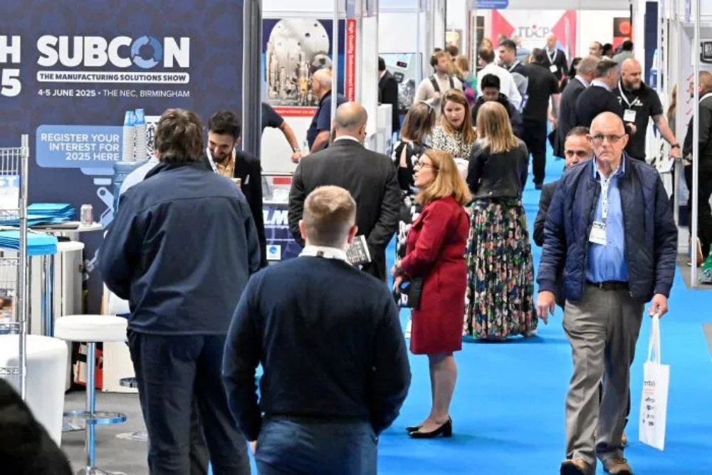 subcon-2026-exhibition-aisle-nec-birmingham Busy exhibition aisle at Subcon 2026 with visitors exploring manufacturing supplier stands