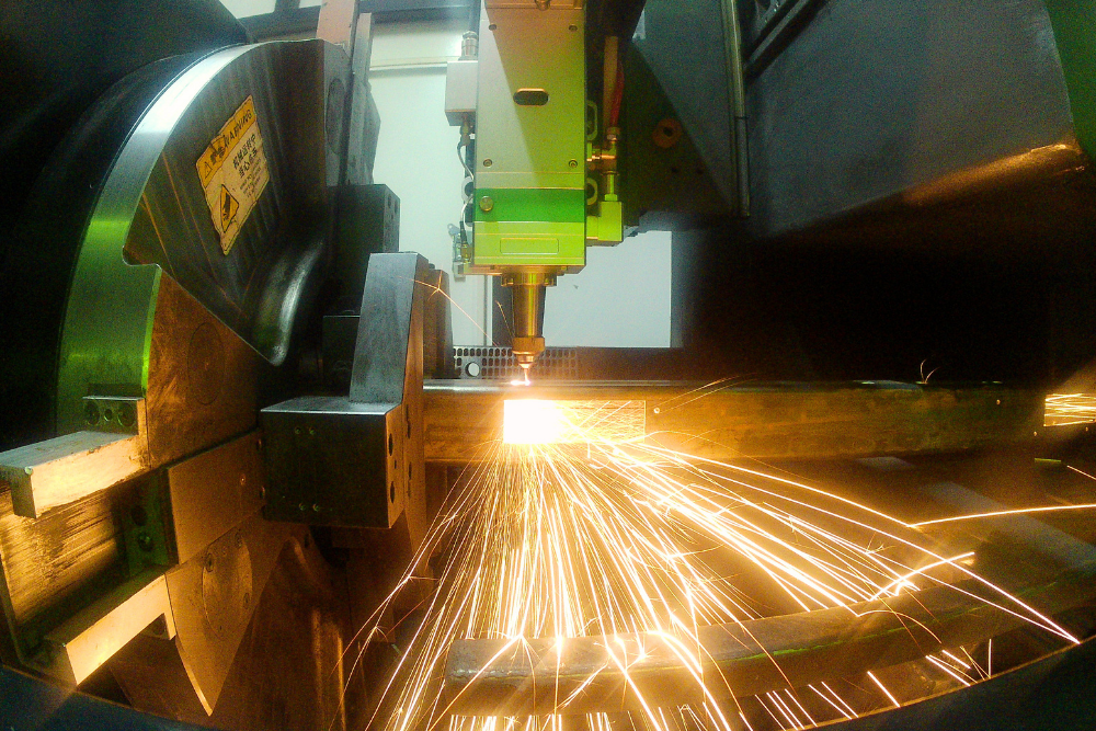 Tube laser cutting steel sections at Grenville Engineering for precision fabricated components.