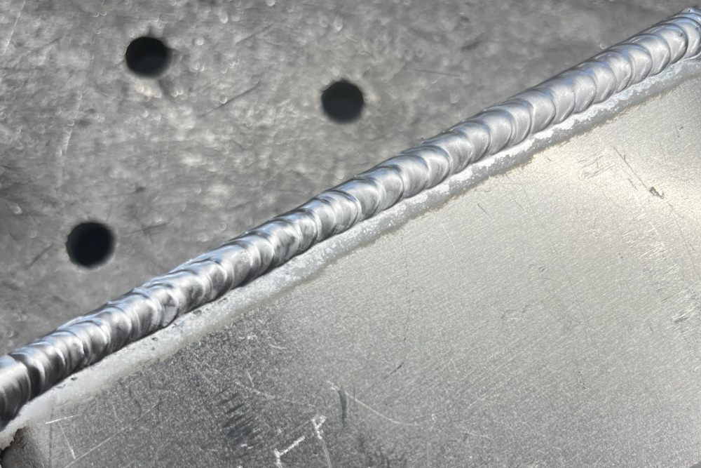 3. harry-precision-welding-engineering-component Close-up of precision welding completed by Harry on an engineering component.