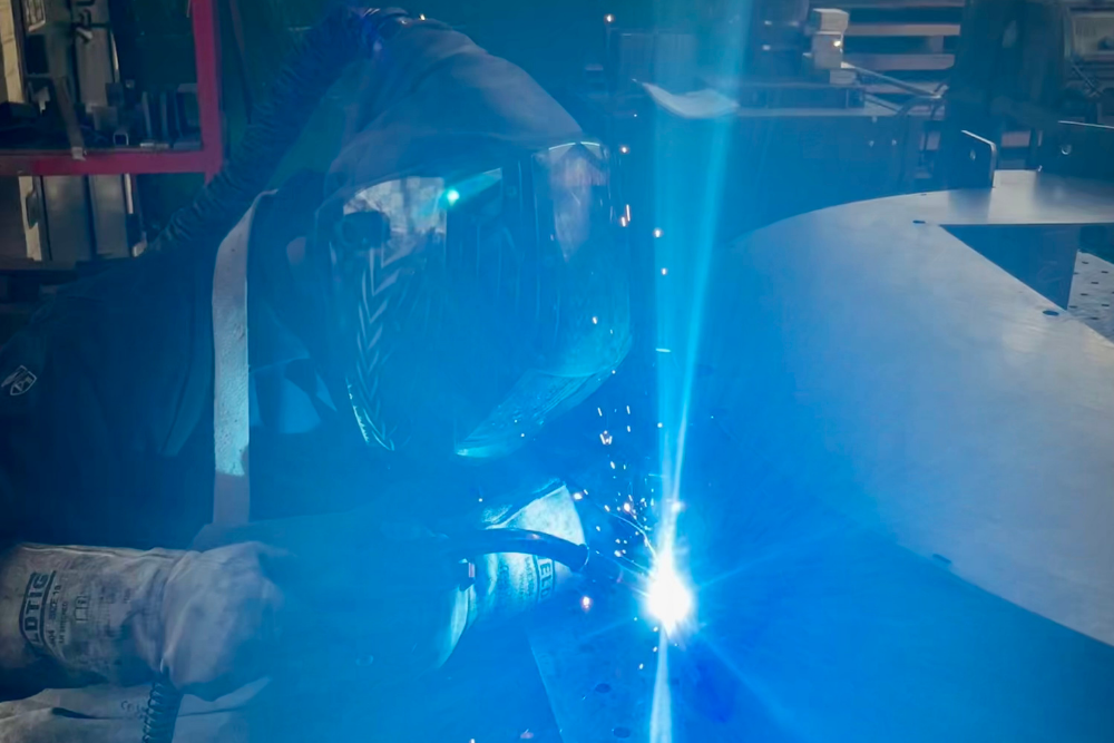 harry-welding-grenville-engineering-shop-floor Harry welding a metal fabrication on the shop floor at Grenville Engineering.